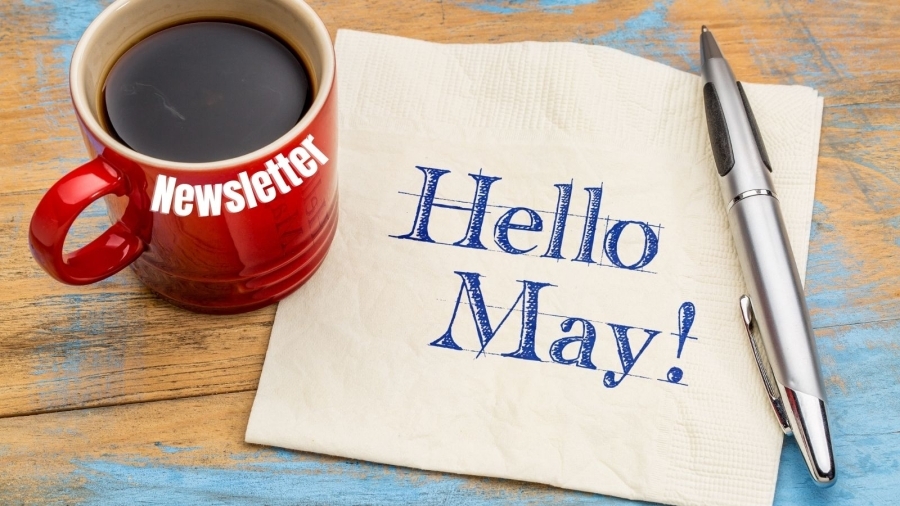 Newsletter on coffee cup and "Hello May" on piece of paper